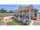 Backyard with an open pergola patio, a grill, a block wall, and seating at 2595 Amber Crest St, Las Vegas, NV 89142