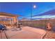 Backyard with a covered patio and cozy outdoor seating area, ideal for relaxing and entertaining at 2595 Amber Crest St, Las Vegas, NV 89142