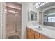 Bathroom featuring a walk-in shower, vanity with double mirrors, and tile flooring at 2595 Amber Crest St, Las Vegas, NV 89142