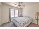 Bright bedroom features a ceiling fan, window, and cozy quilt on the bed at 2595 Amber Crest St, Las Vegas, NV 89142