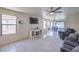 Bright living room with large windows and a decorative fireplace at 2595 Amber Crest St, Las Vegas, NV 89142