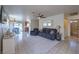 Cozy living room with tile floors, a ceiling fan, and access to the dining area at 2595 Amber Crest St, Las Vegas, NV 89142