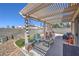 Shaded patio with pergola cover has outdoor seating area and easy access to the backyard at 2595 Amber Crest St, Las Vegas, NV 89142