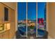 Modern dining area with stunning city views through floor-to-ceiling windows, complemented by stylish cabinets at 2747 Paradise Rd # Ph 3604, Las Vegas, NV 89109