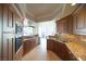 Elegant kitchen with granite countertops, wood cabinetry, and stainless steel appliances at 2777 Paradise Rd # 1505, Las Vegas, NV 89109