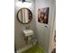 Bathroom featuring a sink, modern faucet, a round mirror and a whimsical painting at 2855 Rice St, Logandale, NV 89021