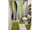 Cozy bathroom with a toilet, a shower featuring a colorful shower curtain, and tile flooring at 2855 Rice St, Logandale, NV 89021