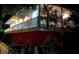 The exterior of the home has a second-floor balcony and is illuminated by the night sky and exterior lighting at 2855 Rice St, Logandale, NV 89021