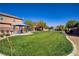 Lush community park with vibrant green grass, covered picnic areas, desert landscaping, and walking paths at 320 Point Loma Ave, North Las Vegas, NV 89031