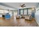 Open-concept living area with a ceiling fan and seamless flow to kitchen at 320 Point Loma Ave, North Las Vegas, NV 89031