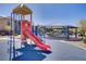 Playground with a red slide and blue climbing structure next to a covered picnic area and desert landscaping at 320 Point Loma Ave, North Las Vegas, NV 89031