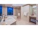 Elegant bathroom with dual sinks, soaking tub, glass shower, and a stunning city view at 322 Karen Ave # 2807, Las Vegas, NV 89109