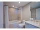 Bathroom featuring a combined tub and shower, neutral tile and white fixtures at 322 Karen Ave # 2807, Las Vegas, NV 89109