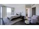 This bedroom features hardwood floors, a large window, and a seating area at 322 Karen Ave # 2807, Las Vegas, NV 89109