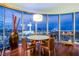 Modern dining room featuring wood floors, a round table set, and floor to ceiling windows with city views at 322 Karen Ave # 2807, Las Vegas, NV 89109