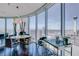 A modern dining area with floor to ceiling windows and a panoramic view of the city at 322 Karen Ave # 2807, Las Vegas, NV 89109
