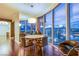 Contemporary dining room with a round table, city views, and stylish decor, complemented by hardwood floors at 322 Karen Ave # 2807, Las Vegas, NV 89109