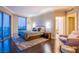 Comfortable main bedroom featuring dark wood floors, cityscape views, and ensuite bathroom at 322 Karen Ave # 2807, Las Vegas, NV 89109