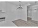Bright dining area featuring modern light fixture and entry to full bathroom at 3318 N Decatur Blvd # 1035, Las Vegas, NV 89130