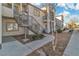 Exterior view of an apartment building featuring staircases and well-maintained landscaping at 3318 N Decatur Blvd # 1035, Las Vegas, NV 89130