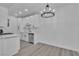 Modern kitchen featuring white cabinets, stainless steel appliances, and a statement chandelier at 3318 N Decatur Blvd # 1035, Las Vegas, NV 89130