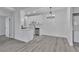 Modern kitchen featuring white cabinets, stainless steel appliances, and light wood flooring at 3318 N Decatur Blvd # 1035, Las Vegas, NV 89130