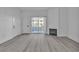Living room featuring light wood flooring, a fireplace, and sliding glass doors that lead to an outdoor area at 3318 N Decatur Blvd # 1035, Las Vegas, NV 89130