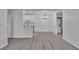 Open-concept living space with light wood flooring, white walls, a modern light fixture, and laundry appliances at 3318 N Decatur Blvd # 1035, Las Vegas, NV 89130