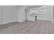 Bright living room with modern light fixture, white walls, and light wood flooring that connects to a modern kitchen at 3318 N Decatur Blvd # 1035, Las Vegas, NV 89130