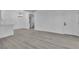 Open-concept living space with light wood flooring, white walls, a modern light fixture, and an entry door at 3318 N Decatur Blvd # 1035, Las Vegas, NV 89130