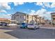Apartment building view with multiple parked cars in the lot on a bright, sunny day at 3318 N Decatur Blvd # 1035, Las Vegas, NV 89130
