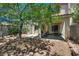 Private backyard with a patio, lush greenery, and shade trees at 4487 Tomer Ln, Las Vegas, NV 89121