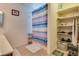 Bright bathroom featuring a shower over tub, tile flooring, and built-in storage shelves, perfect for organization at 4487 Tomer Ln, Las Vegas, NV 89121