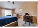 This bedroom features carpet flooring, a ceiling fan, natural light, and access to the en suite bathroom at 4487 Tomer Ln, Las Vegas, NV 89121