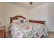 Bright bedroom featuring a wooden headboard bed with colorful bedding and matching dark wood dresser at 4487 Tomer Ln, Las Vegas, NV 89121