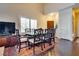 Elegant dining room with decorative chairs, a dark wood table, and natural light from the window at 4487 Tomer Ln, Las Vegas, NV 89121