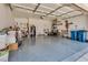 Spacious and organized two car garage with ample storage and painted concrete flooring at 4487 Tomer Ln, Las Vegas, NV 89121