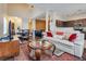 Open concept living area features plush seating, fireplace, and an airy layout adjacent to the kitchen at 4487 Tomer Ln, Las Vegas, NV 89121