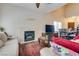Cozy living room with fireplace adjacent to the dining area features comfortable seating and natural light at 4487 Tomer Ln, Las Vegas, NV 89121