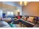 A cozy living area features plush seating, a patterned rug, and an open layout connected to the dining area at 4487 Tomer Ln, Las Vegas, NV 89121