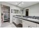 Bathroom featuring double sinks, a large mirror, and a glass-enclosed shower at 450 Intrepid Ct, Boulder City, NV 89005