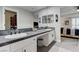 Bathroom featuring double sinks, a large mirror, and views to the bedroom at 450 Intrepid Ct, Boulder City, NV 89005