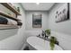 Bright bathroom featuring a soaking tub with wood-trimmed mirror and shelves at 450 Intrepid Ct, Boulder City, NV 89005