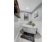 Bright bathroom featuring a soaking tub, wood-trimmed mirror, and grey tiled floor at 450 Intrepid Ct, Boulder City, NV 89005