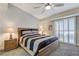 Bedroom featuring a modern ceiling fan and a bed with black and gray striped bedding at 450 Intrepid Ct, Boulder City, NV 89005