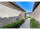 Scenic walkway with lush landscaping and an artful wall hanging at 450 Intrepid Ct, Boulder City, NV 89005