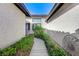 Inviting walkway leading to the front door with well-maintained landscaping on either side at 450 Intrepid Ct, Boulder City, NV 89005