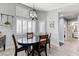 Bright dining room with wood-look floors, shuttered windows and modern lighting fixture at 450 Intrepid Ct, Boulder City, NV 89005