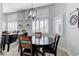 Charming dining area with a round table and views of the mirrored wall and window shutters at 450 Intrepid Ct, Boulder City, NV 89005