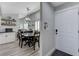 Open-concept dining area featuring modern light fixture and laminate flooring with front door at 450 Intrepid Ct, Boulder City, NV 89005